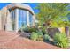 Contemporary home with large windows and desert landscaping at 10040 E Happy Valley Rd # 1047, Scottsdale, AZ 85255