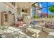 Sunlit living room with multiple seating areas and large windows at 10040 E Happy Valley Rd # 1047, Scottsdale, AZ 85255