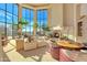Bright living room with large windows, fireplace and ample seating at 10040 E Happy Valley Rd # 1047, Scottsdale, AZ 85255
