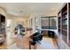 Spacious home office with a large desk, built-in bookshelves, and a sitting area at 10040 E Happy Valley Rd # 1047, Scottsdale, AZ 85255