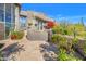 Flagstone patio with lush desert landscaping and a large window at 10040 E Happy Valley Rd # 1047, Scottsdale, AZ 85255