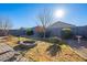 Landscaped backyard featuring a fire pit and mature trees at 10421 E Cliffrose Ln, Florence, AZ 85132