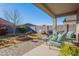 Covered patio with seating area, fire pit, and grill at 10421 E Cliffrose Ln, Florence, AZ 85132