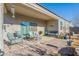 Relaxing covered patio with seating area, fire pit, and landscaped yard at 10421 E Cliffrose Ln, Florence, AZ 85132