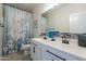 Clean bathroom with double vanity, tile accents, and shower at 10421 E Cliffrose Ln, Florence, AZ 85132