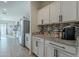 Modern kitchen with white cabinets, granite counters, and stainless steel appliances at 10421 E Cliffrose Ln, Florence, AZ 85132