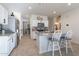 Kitchen with island, white cabinets, and breakfast bar at 10421 E Cliffrose Ln, Florence, AZ 85132