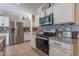 Modern kitchen featuring stainless steel appliances and granite countertops at 10421 E Cliffrose Ln, Florence, AZ 85132