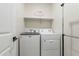 Laundry room with washer, dryer, and shelving at 10421 E Cliffrose Ln, Florence, AZ 85132