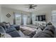 Bright living room with a sectional sofa and large TV at 10421 E Cliffrose Ln, Florence, AZ 85132