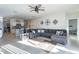 Spacious living room featuring a large sectional sofa and ceiling fan at 10421 E Cliffrose Ln, Florence, AZ 85132
