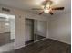 Bedroom with mirrored closet doors and wood-look floors at 1069 N 84Th Pl, Scottsdale, AZ 85257