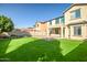 Spacious backyard featuring a large grassy area and patio at 10789 W Saddlehorn Rd, Peoria, AZ 85383