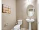 Powder room with pedestal sink and oval mirror at 10789 W Saddlehorn Rd, Peoria, AZ 85383