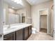 Bathroom features a vanity with dark brown cabinets and a shower/tub combo at 10789 W Saddlehorn Rd, Peoria, AZ 85383