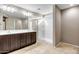 Modern bathroom with double vanity, large mirror, and walk-in shower at 10789 W Saddlehorn Rd, Peoria, AZ 85383