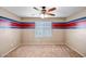 Bedroom with blue and red accent wall and ceiling fan at 10789 W Saddlehorn Rd, Peoria, AZ 85383