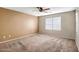 Spacious bedroom with carpeted floor, ceiling fan, and window coverings at 10789 W Saddlehorn Rd, Peoria, AZ 85383