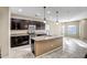 Kitchen with dark brown cabinets and granite countertops at 10789 W Saddlehorn Rd, Peoria, AZ 85383