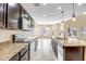 Kitchen with dark brown cabinets and granite countertops at 10789 W Saddlehorn Rd, Peoria, AZ 85383