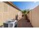 Side yard with gravel, a small palm tree, and AC unit at 11038 W Tonto Ln, Peoria, AZ 85373