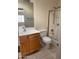 Clean bathroom, shower/tub combo, wood vanity, and tile flooring at 1120 S 232Nd Ave, Buckeye, AZ 85326