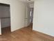 Spacious bedroom with wood flooring and access to a hallway at 1120 S 232Nd Ave, Buckeye, AZ 85326