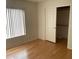 Light and airy bedroom with wood flooring and ample closet space at 1120 S 232Nd Ave, Buckeye, AZ 85326