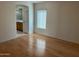 Bright bedroom with wood flooring and access to bathroom at 1120 S 232Nd Ave, Buckeye, AZ 85326