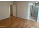 Large bedroom with wood flooring and access to bathroom at 1120 S 232Nd Ave, Buckeye, AZ 85326