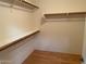 Spacious walk-in closet with wood shelving and flooring at 1120 S 232Nd Ave, Buckeye, AZ 85326