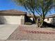 House exterior with a two-car garage and landscaping at 1120 S 232Nd Ave, Buckeye, AZ 85326