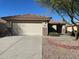 House exterior with a two-car garage and landscaping at 1120 S 232Nd Ave, Buckeye, AZ 85326