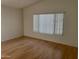 Living room with large window and wood flooring at 1120 S 232Nd Ave, Buckeye, AZ 85326