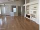 Spacious living room with built-in shelving and hardwood floors at 1120 S 232Nd Ave, Buckeye, AZ 85326
