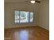 Bright living room with wood flooring and large window with backyard view at 1120 S 232Nd Ave, Buckeye, AZ 85326