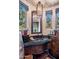 Charming powder room features designer lighting, stone accents, and granite countertop with copper sink at 11237 E Troon Mountain Dr, Scottsdale, AZ 85255