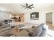 Open living room, featuring a cozy seating area and a view into the kitchen at 11271 E Sunflower Ct, Florence, AZ 85132