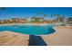 Community pool with palm trees and shaded seating areas at 11271 E Sunflower Ct, Florence, AZ 85132