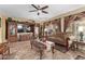 Spacious living room featuring a large TV, comfortable sofa, and decorative accents at 11868 W Kinderman Dr, Avondale, AZ 85323