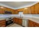 Kitchen with wood cabinets and stainless steel appliances at 1294 N Blackstone Dr, Chandler, AZ 85224