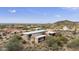 Aerial view of contemporary home with desert landscape and mountain views at 135 E Tonto St, Apache Junction, AZ 85119