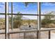 View of a patio and stunning mountain landscape from inside the home at 135 E Tonto St, Apache Junction, AZ 85119