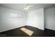 Well-lit bedroom with dark floors, ceiling fan, and double closet at 1431 E 1St St, Mesa, AZ 85203