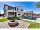 Landscaped backyard with a pool and fire pit at 14428 W Faye Way, Surprise, AZ 85387