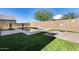 Inviting backyard oasis featuring a sparkling pool, fire pit, and artificial turf at 14428 W Faye Way, Surprise, AZ 85387