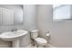 Clean bathroom with pedestal sink and toilet at 14428 W Faye Way, Surprise, AZ 85387