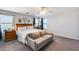 King bed, couch, and wooden dresser in a cozy bedroom at 14428 W Faye Way, Surprise, AZ 85387