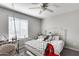 Bedroom with a white bed frame, hanging chair, and vanity at 14428 W Faye Way, Surprise, AZ 85387