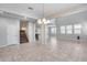 Spacious dining area with tile floors and a staircase at 14428 W Faye Way, Surprise, AZ 85387